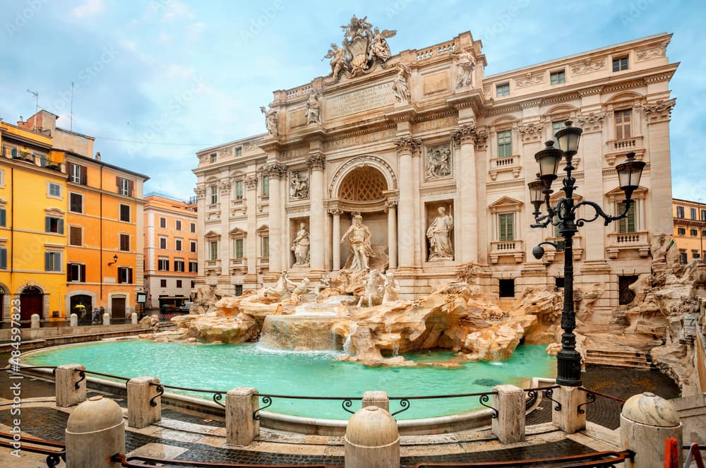 Trevi Fountain in Rome with clear blue water and baroque sculptures.